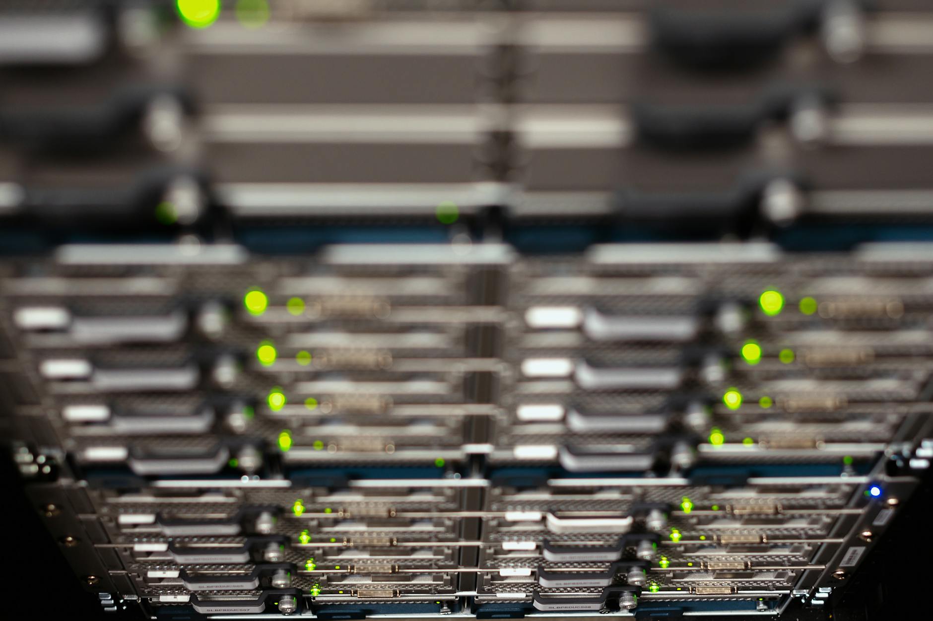 Server racks in a data center lit by blue and orange lights